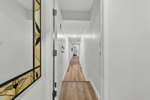 Clean and bright walkway connecting the main areas of the home