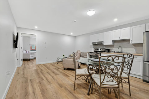 Cozy and functional living room with dining space, entertainment setup, and kitchen view.