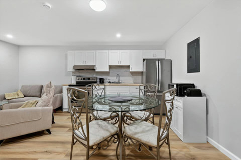 Well-designed living area combining a comfy sofa, dining corner, TV, and open kitchen for easy living