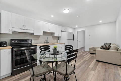 Well-designed living area combining a comfy sofa, dining corner, TV, and open kitchen for easy living