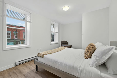 Inviting ensuite bedroom with a neatly arranged queen bed and essential amenities