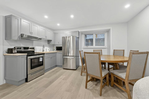 Clean and functional kitchen with a bright dining area for shared meals.