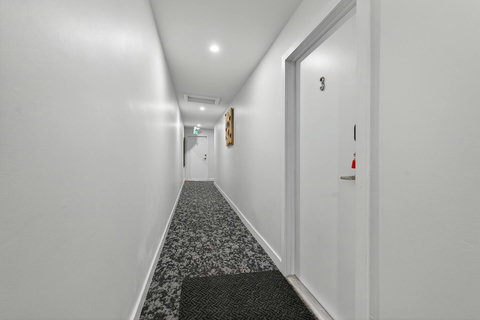 Clean and bright walkway connecting the main areas of the home