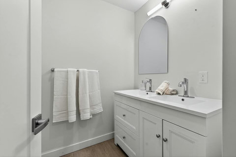 Neatly arranged bathroom shelf with glass accents and fresh towels.