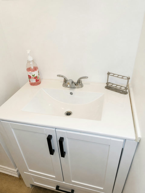 Freshen up in this clean, practical, and inviting bathroom area.