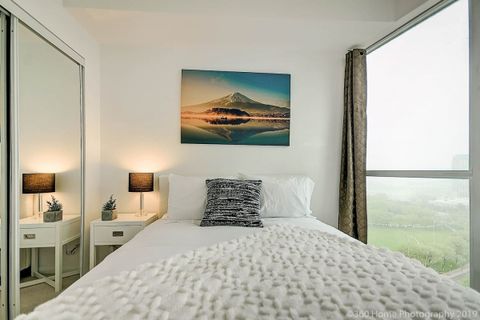 Master bedroom with a comfy queen bed and a serene view from the room.