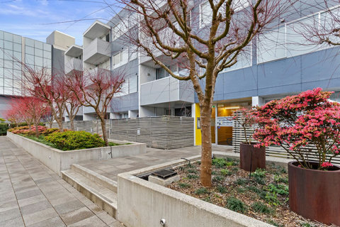 Entrance into the apartment is on the left of the yellow door.
