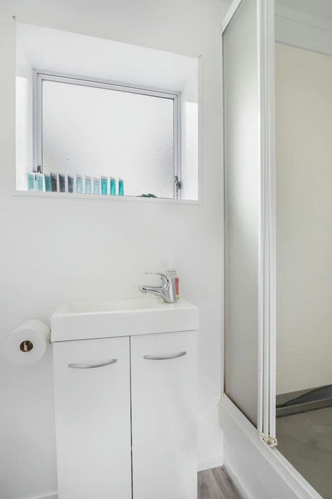 The bathroom consists of a shower, toilet and vanity unit.