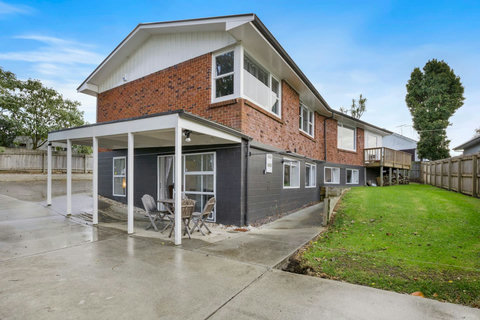 The unit is located underneath the main house with a shared backyard.