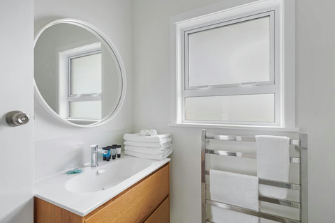 The bathroom has been completely refreshed with new fixtures: mirror, vanity, heated towel rail, shower cabinet and toilet.