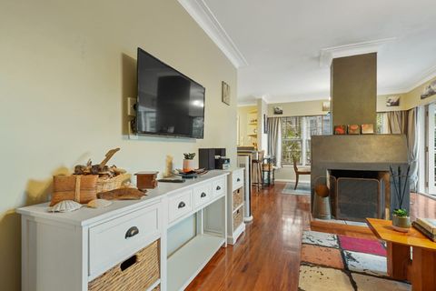 The flatscreen tv is wall mounted and streams FreeView and whatever streaming service you subscribe too. The fire place clearly defines the separate zones in the lounge and dining room spaces.