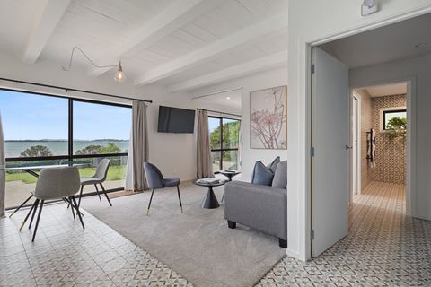 There is a lounge with entry into the adjoining bedroom. To the right is the ensuite bathroom.