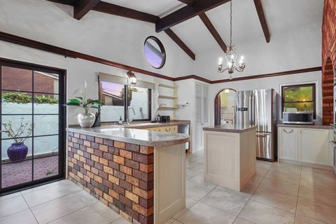 The large kitchen with preparation island bench and large double-door American-style fridge freezer.