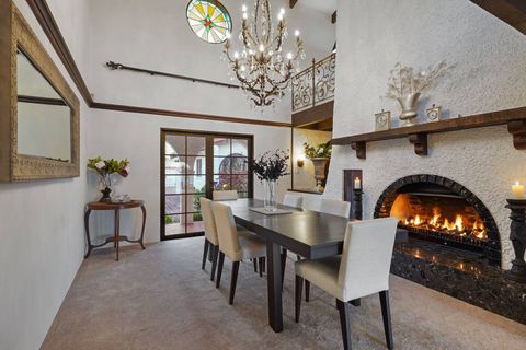 The elegant formal six-seated formal dining room with fireplace and chandelier.