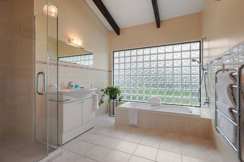 The family bathroom has a separate shower, bathtub, vanity and heated towel rail.