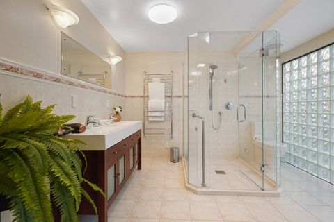 Main ensuite has a shower in the middle of the room with twin sinks.