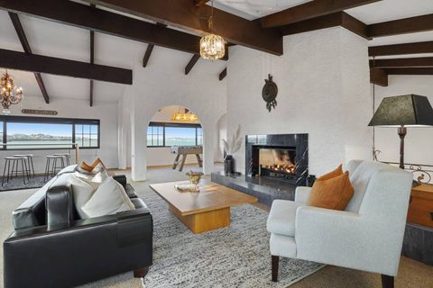 Lounge 1 with the large gas fire place and multiple seating areas. Bar seating is by the windows with sea views.
