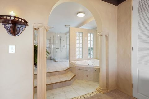 The main suite ensuite bathroom features a bathtub and a separate shower.
