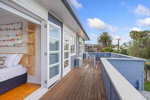 Three of the bedrooms open onto the upstairs balcony and outdoor living area.