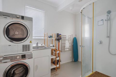 Bathroom 2 also has the front loading washing machine and dryer along with a laundry tub.