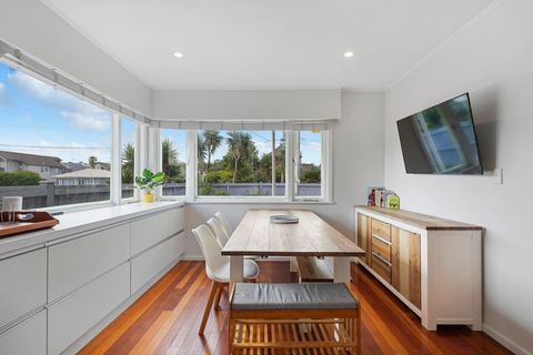The dining room also has a flatscreen tv on the wall.
