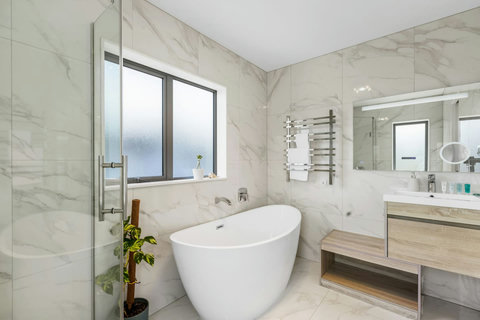 The ensuite bathroom has a stunning bath-tub that you can relax and recharge after a busy day.