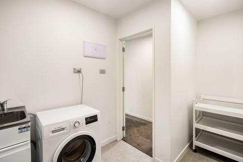 There is a separate laundry that has a laundry tub and a front-loading washing machine.