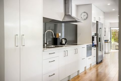The kitchen has been fitted to take up a long wall that would have been a hallway.