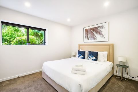 The King bed looks inviting with its crisp white sheets and neutral background.
