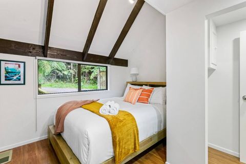 This bedroom is cosy and inviting with bold colours in soft furnishings.