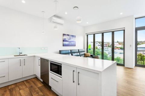 A peninsular island bench is perfect to divide the open-plan living area.