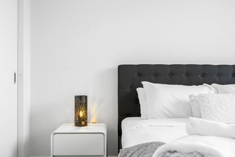 The bedroom features interesting bedside lamps that will look amazing at night.
