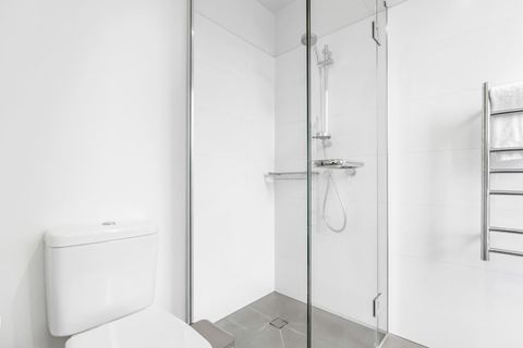 The ensuite bathroom has a shower, toilet, vanity and heated towel rail.