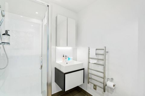 The ensuite bathroom has a shower cabinet, mirror vanity, toilet and heated towel rail.