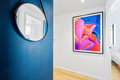 This artwork colours compliments the blue wall in the entryway.