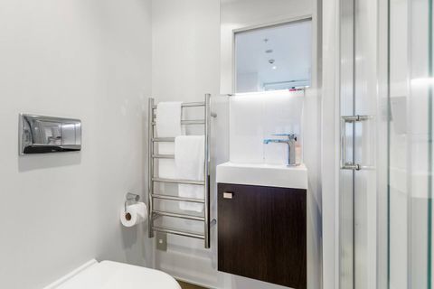 The second bathroom has a toilet, shower, vanity unit and heated towel rail.