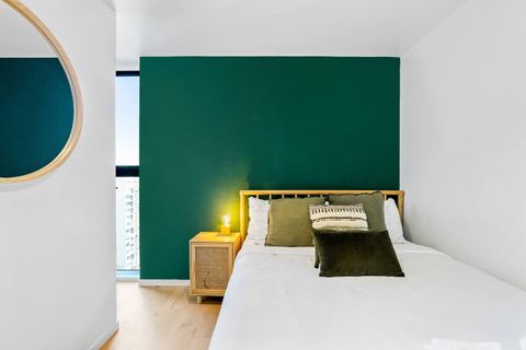 The double bedroom features a green feature wall that gives the room a focal point.