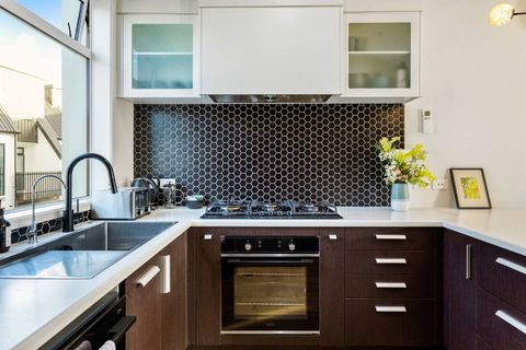 There is a builtin oven with a 6 burner gas cook top with an extractor fan.