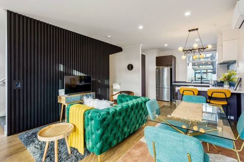 The slatted wall shields the stairs up to the bedrooms.