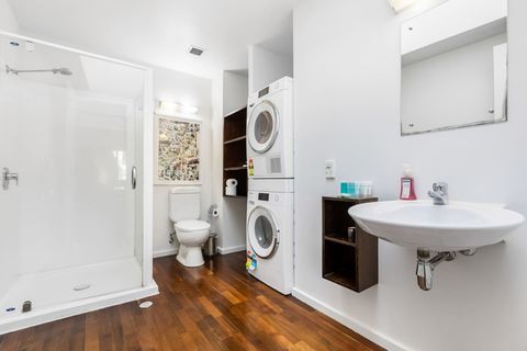 The bathroom includes the full laundry with front loading washing machine and dryer.