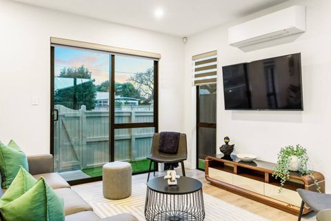 The lounge has a ranchslider and a wall mounted TV.