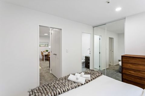View into the ensuite bathroom and storage cupboards.
