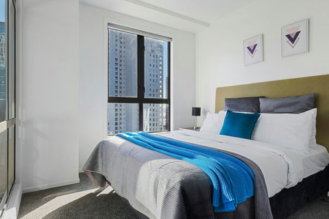 Lovely queen bed with blue and mustard accents. Floor to ceiling windows let in the sun and gives you a great view.