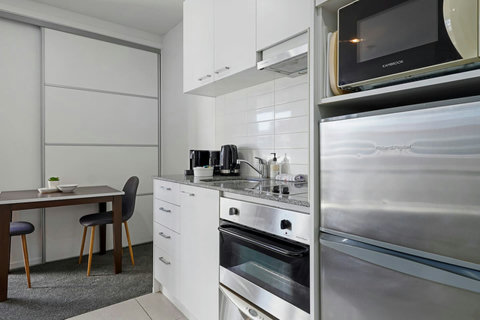 There is a full kitchen with cook top, oven, microwave and fridge/freezer.