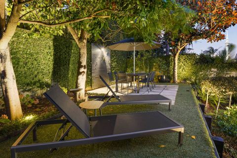 The upper garden contains sun loungers and another dining space.