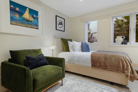 There is even space for this beautiful green velvet chair that would be perfect to curl up with a book.