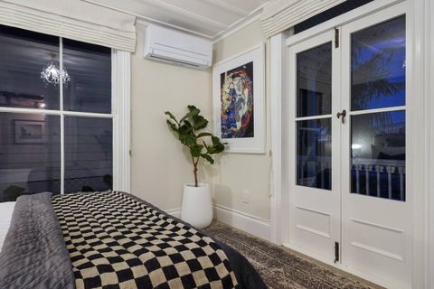 The French doors open on to the front porch.
It also has Roman blinds for privacy over the large sash windows and doors.