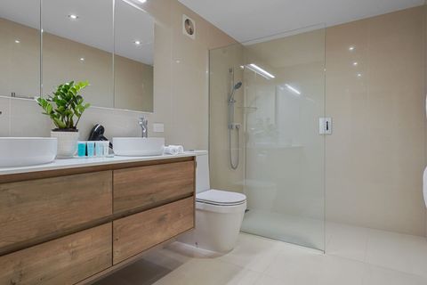 The bathroom on the ground floor is shared by bedrooms 3 and 4. With dual sinks, a large shower and mirrors there should be no fighting over sink space.