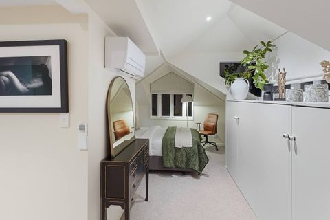With touches of artwork throughout and the antique dresser, this bedroom has lots of visual elements which provide a sense of interest.
