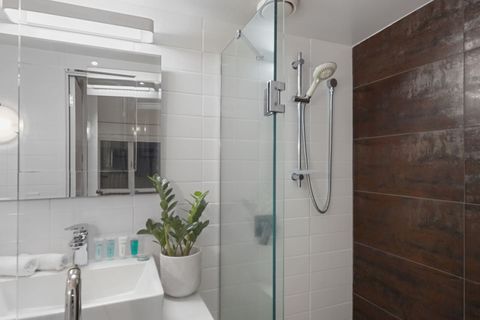 The boutique ensuite bathroom in the master suite is smartly designed and hidden away in a corner.